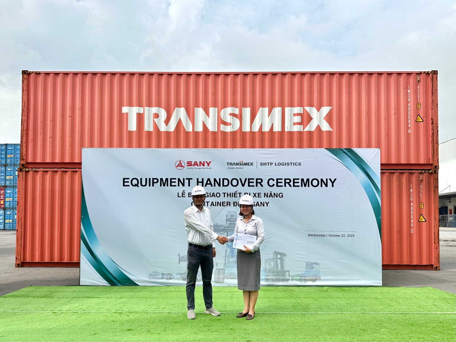 A person and person standing in front of a large signAI-generated content may be incorrect.